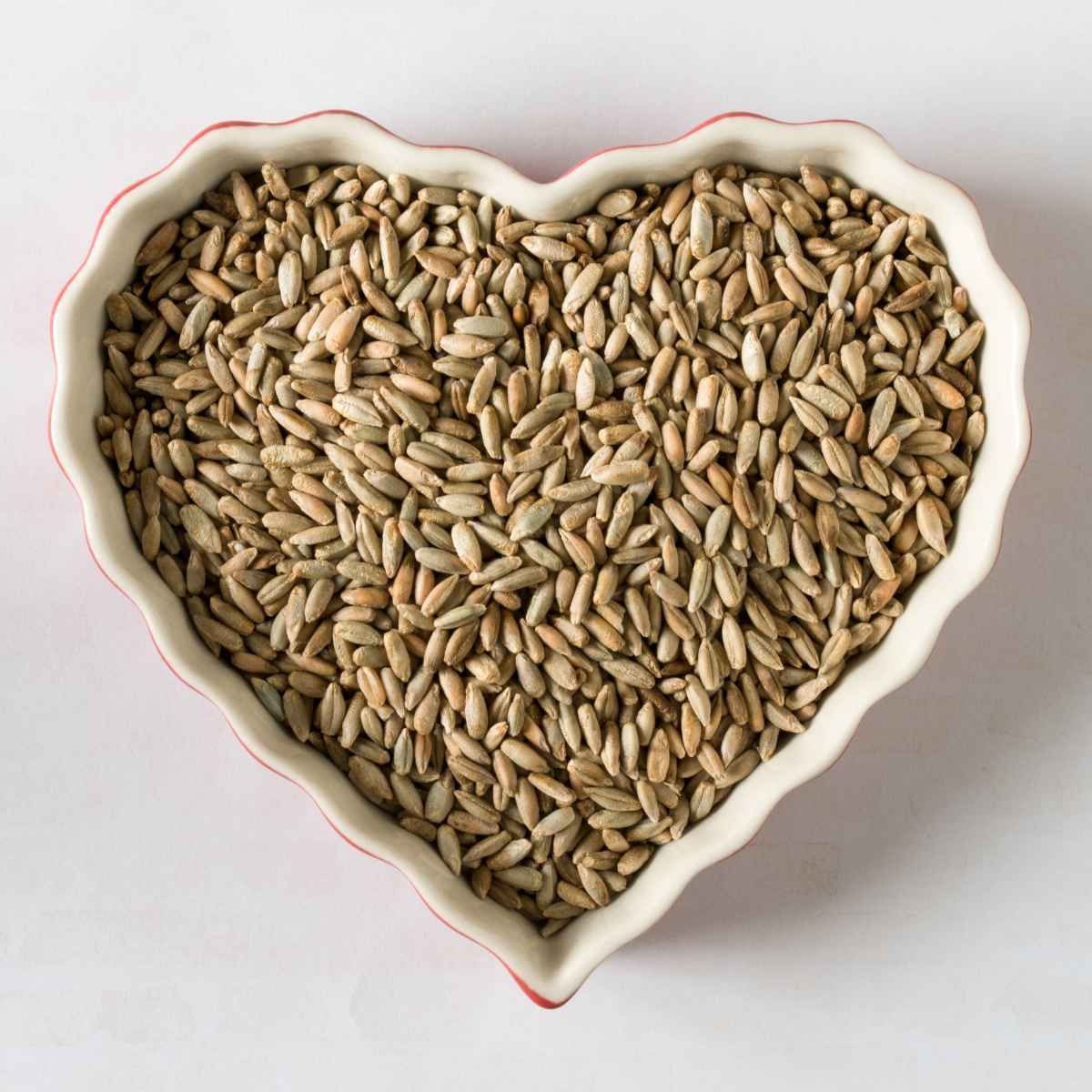 Rye Berries placed in a heart shaped bowl.