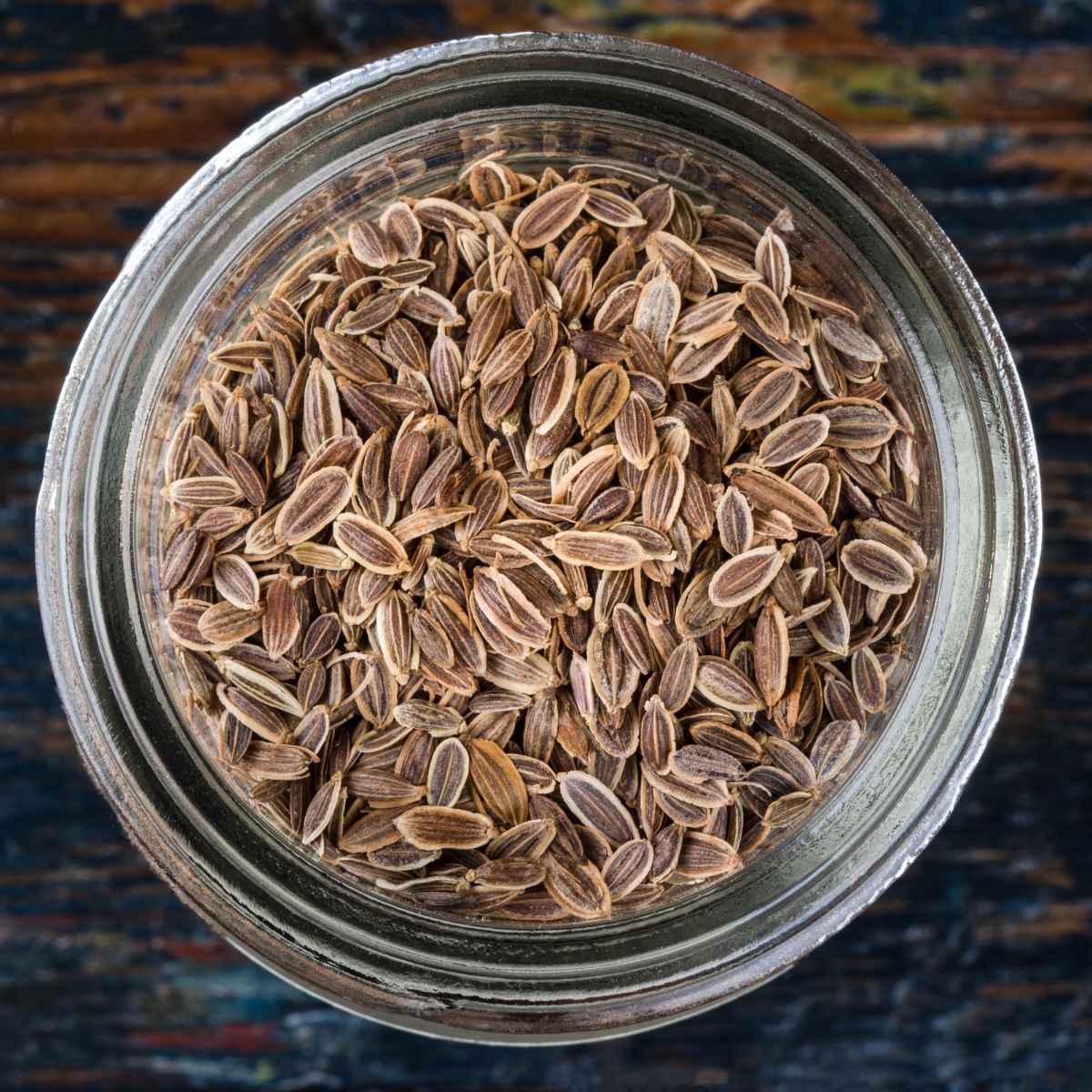 Dill seeds in a glass jar.