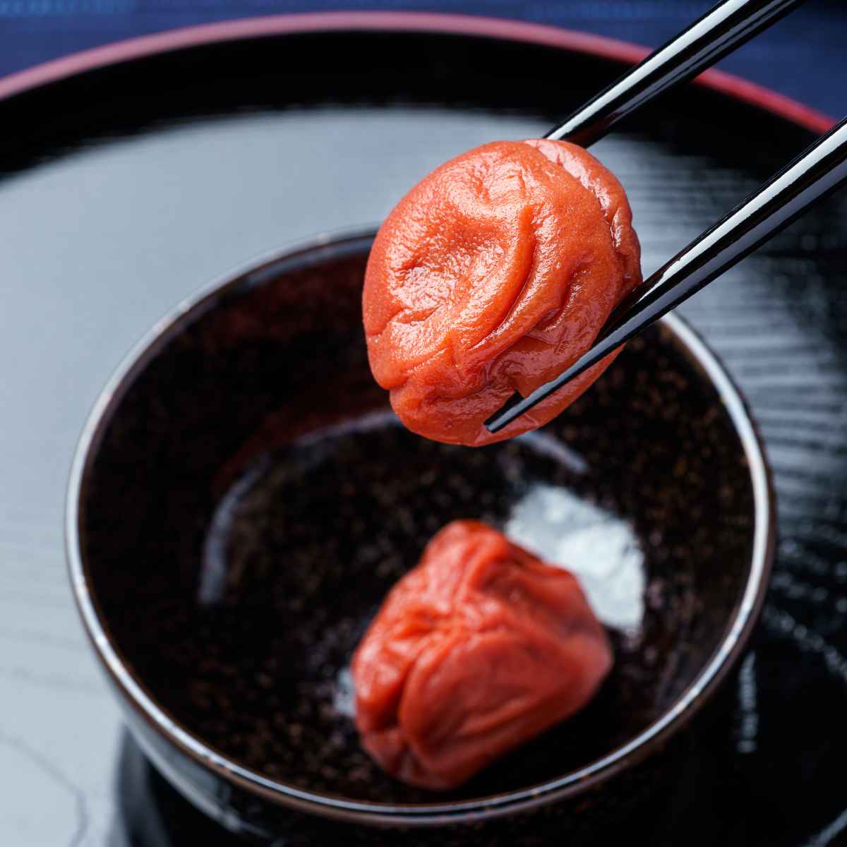 Umeboshi in a black bowl.