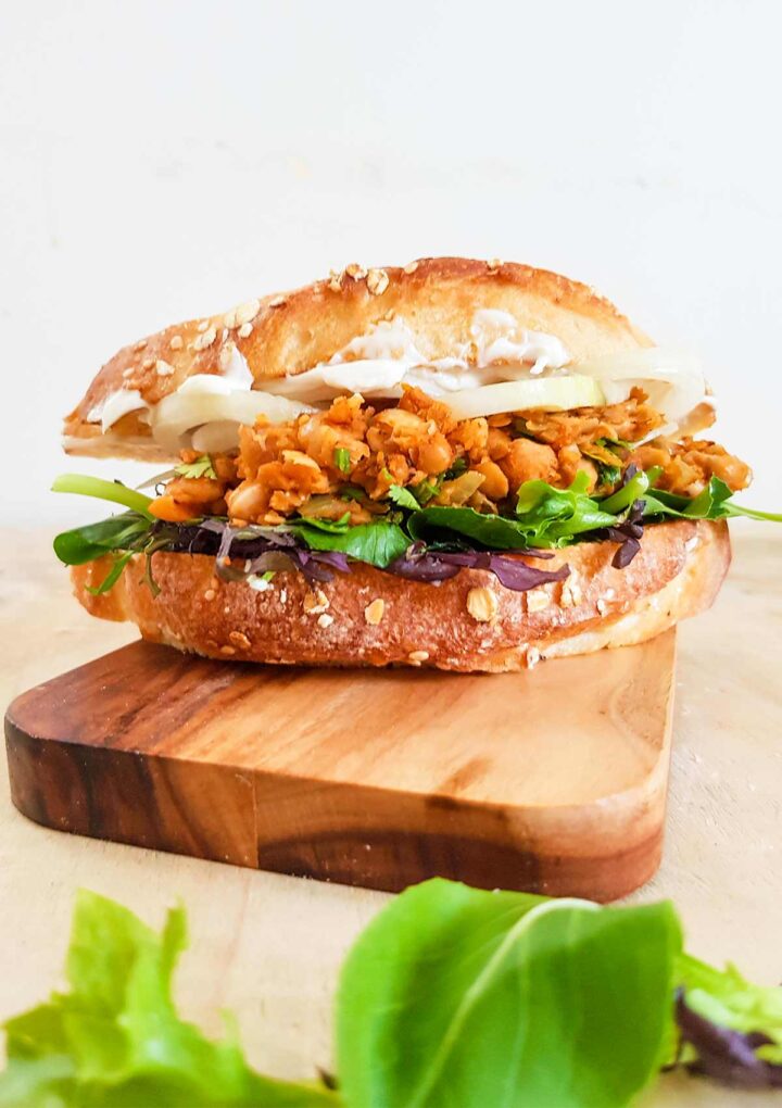 vegan chickpea sandwich placed on a wooden board