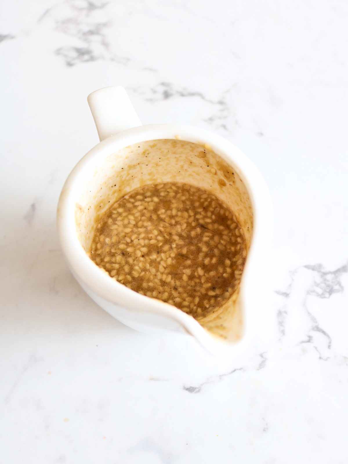 Tahini dressing in a cup.