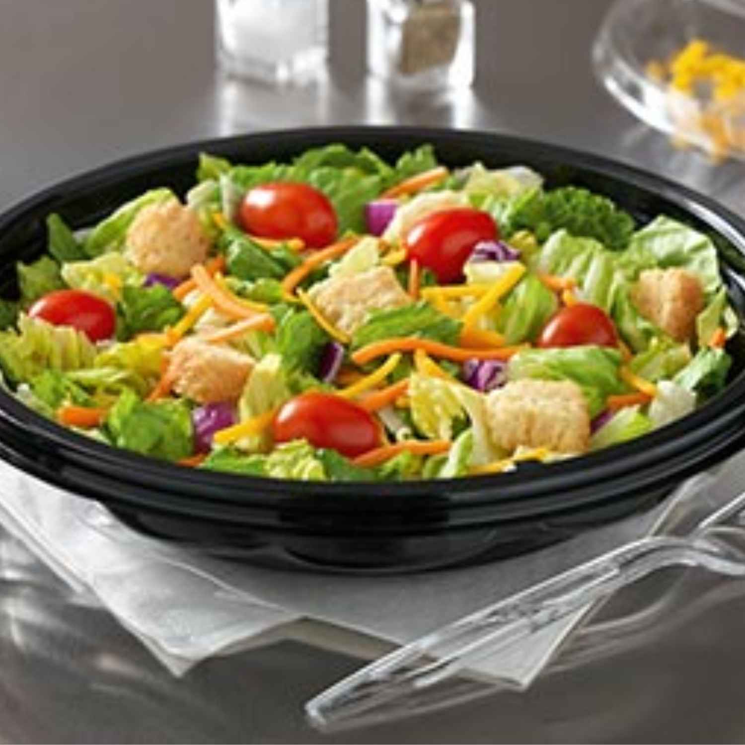 Classic garden salad served in a black bowl.