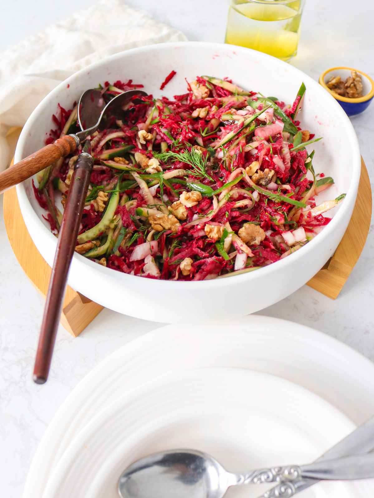 Garnish the Cucumber Beetroot Salad with walnuts and dill.
