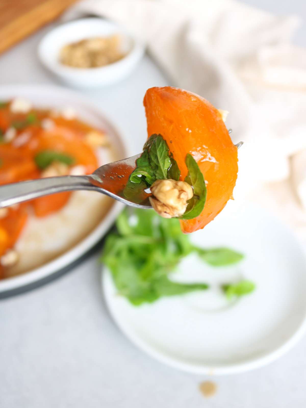 Persimmon salad on a fork.