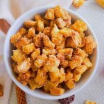 Salted caramel bread croutons served in a white color bowl