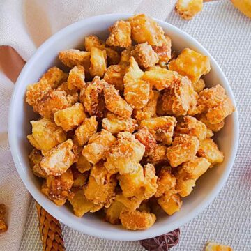 Salted caramel bread croutons served in a white color bowl